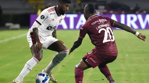 Rodinei of Flamengo fights for the ball Junior Hernández of Deportes Tolima