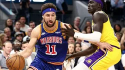 Klay Thompson of the Golden State Warriors is guarded by Wenyen Gabriel of the Los Angeles Lakers