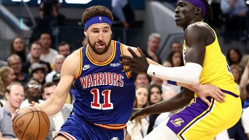 Klay Thompson of the Golden State Warriors is guarded by Wenyen Gabriel of the Los Angeles Lakers