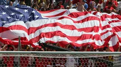 Fans hold up the American flag during a game