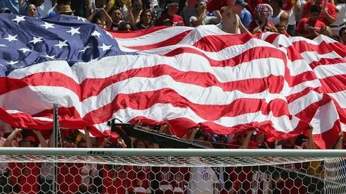 Fans hold up the American flag during a game