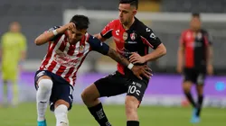 Gonzalo Maroni of Atlas fights for the ball with Alexis Vega of Chivas