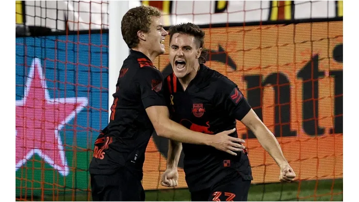 Aaron Long of New York Red Bulls celebrates his goal with teammate Tom Barlow