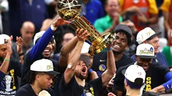 Stephen Curry of the Golden State Warriors raises the Larry O'Brien Championship Trophy