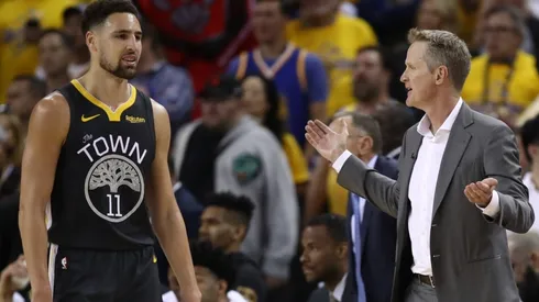 Klay Thompson #11 and Head coach Steve Kerr of the Golden State Warriors
