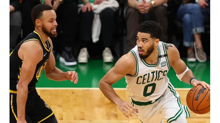 Jayson Tatum of the Boston Celtics drives past Stephen Curry of the Golden State Warriors