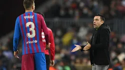 Gerard Pique (left) and Barcelona coach Xavi Hernandez.