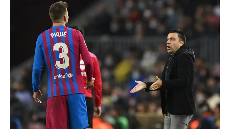 Gerard Pique (left) and Barcelona coach Xavi Hernandez.