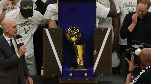NBA commissioner Adam Silver presents the NBA title trophy at the 2021 NBA Finals