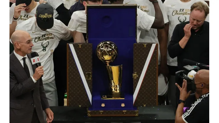 NBA commissioner Adam Silver presents the NBA title trophy at the 2021 NBA Finals