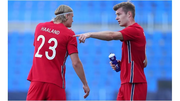 Erling Haaland of Norway speaks with team mate Patrick Berg
