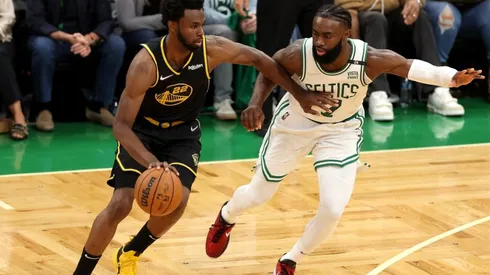 Andrew Wiggins of the Golden State Warriors drives to the basket against Jaylen Brown of the Boston Celtics