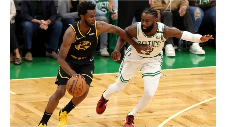 Andrew Wiggins of the Golden State Warriors drives to the basket against Jaylen Brown of the Boston Celtics