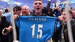 A fan holding a Manchester City shirt