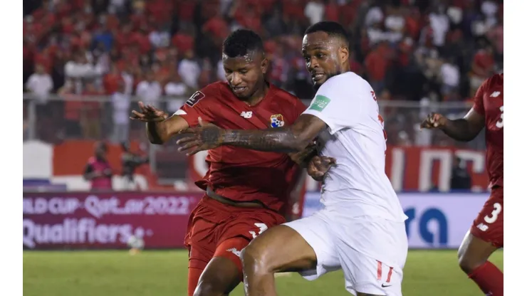 Fidel Escobar of Panama fights for the ball with Cyle Larin of Canada