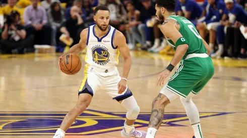 Stephen Curry of the Golden State Warriors dribbles against Jayson Tatum of the Boston Celtics