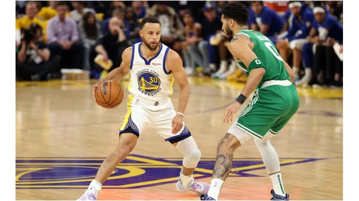 Stephen Curry of the Golden State Warriors dribbles against Jayson Tatum of the Boston Celtics