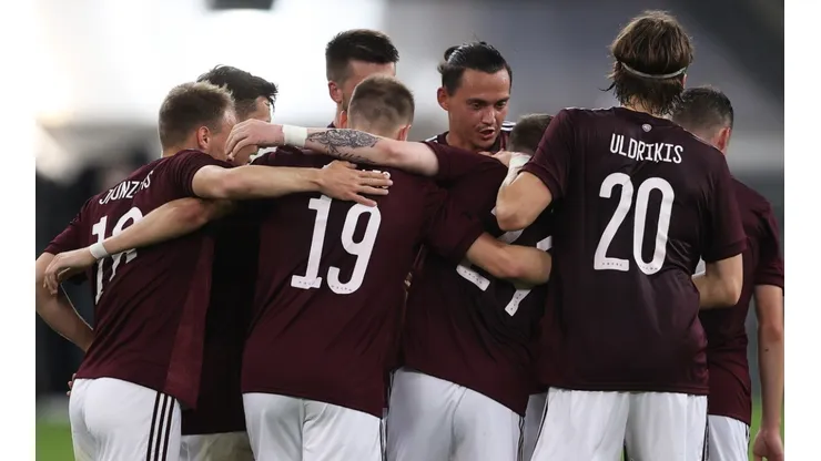Latvia players celebrate after scoring