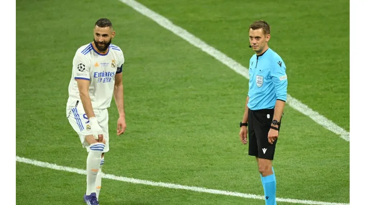 Karim Benzema of Real Madrid and Referee Clement Turpin look on as they wait for the result of a VAR review