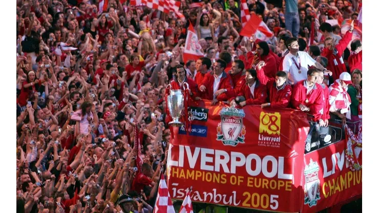 Liverpool team rides on an open top bus through a mass of fans as they arrive at St. George's Hall during the Liverpool Champions League Victory Parade on May 26, 2005