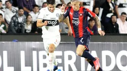 Ivan Torres of Olimpia competes for the ball with Alan Benitez of Cerro Porteño
