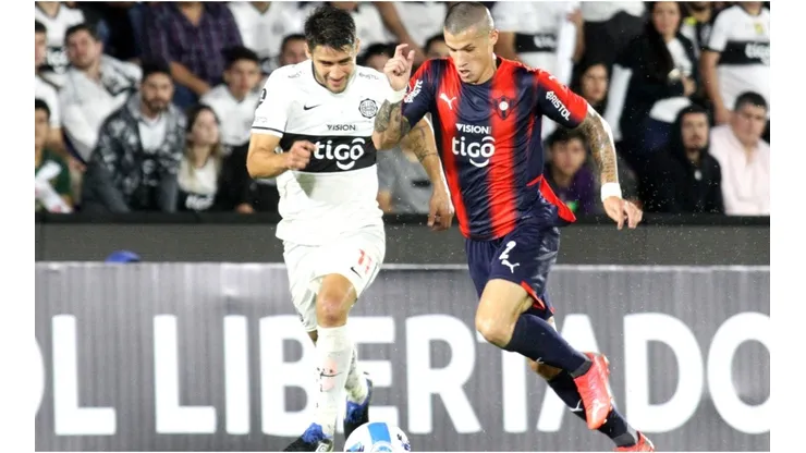 Ivan Torres of Olimpia competes for the ball with Alan Benitez of Cerro Porteño