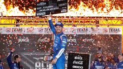 Kyle Larson raises his award for winning the Nascar All-Star Race