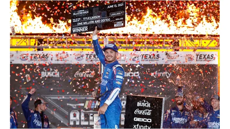 Kyle Larson raises his award for winning the Nascar All-Star Race