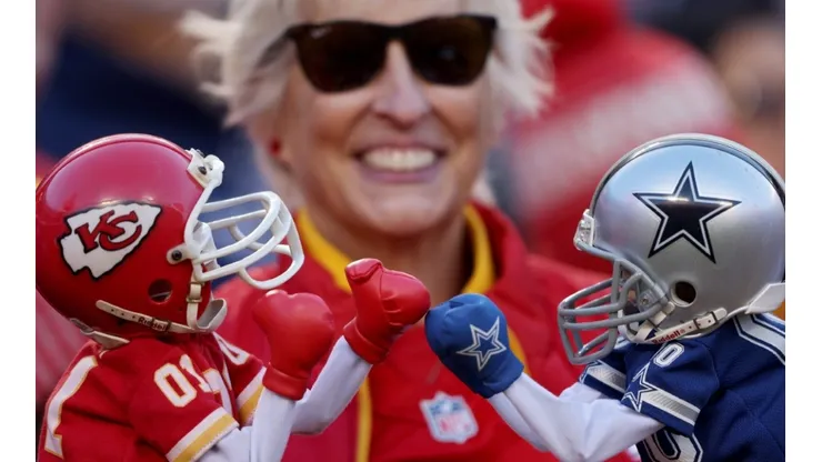 Fan with two Chiefs and Cowboys toys