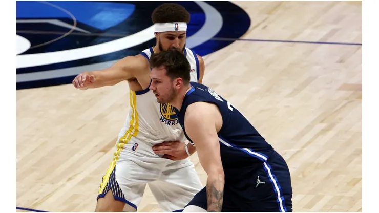 Luka Doncic of the Dallas Mavericks drives past Klay Thompson of the Golden State Warriors