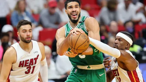 Jayson Tatum of the Boston Celtics drives to the basket against Max Strus and Jimmy Butler of the Miami Heat