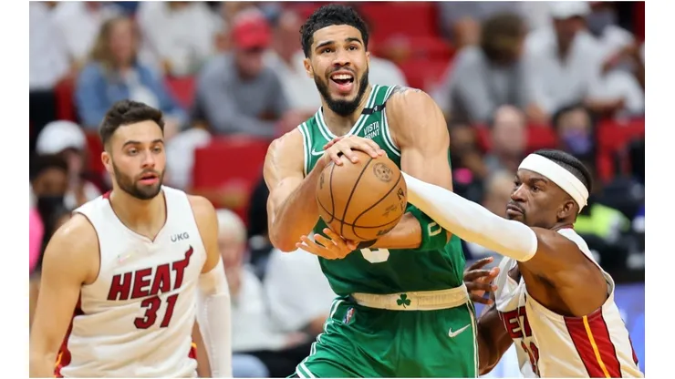 Jayson Tatum of the Boston Celtics drives to the basket against Max Strus and Jimmy Butler of the Miami Heat