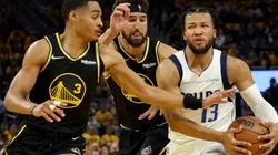 Jalen Brunson of the Dallas Mavericks is defended by Jordan Poole and Klay Thompson of the Golden State Warriors