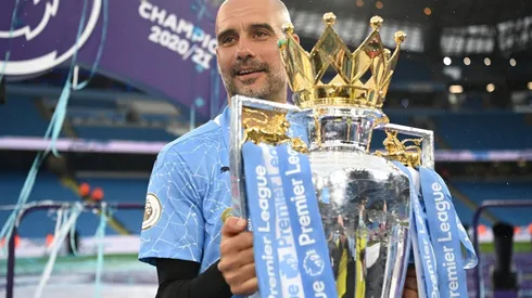 Pep Guardiola celebrates with the 2021-22 Premier League Trophy