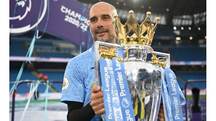 Pep Guardiola celebrates with the 2021-22 Premier League Trophy