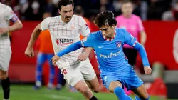 Thomas Delaney of Sevilla and Joao Felix of Atletico Madrid