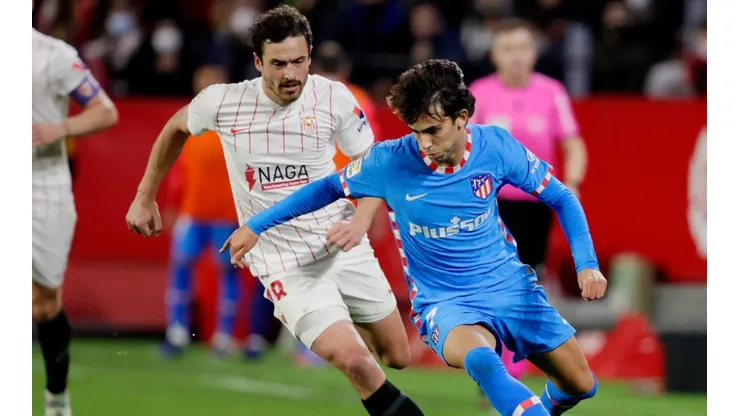 Thomas Delaney of Sevilla and Joao Felix of Atletico Madrid