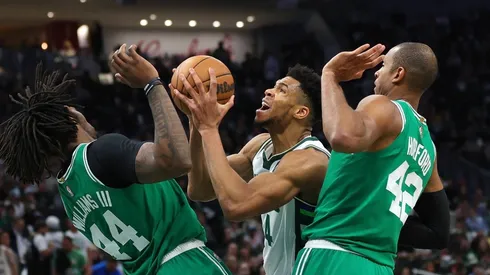 Giannis Antetokounmpo of the Milwaukee Bucks guard by Robert Williams III and Al Horford of the Boston Celtics