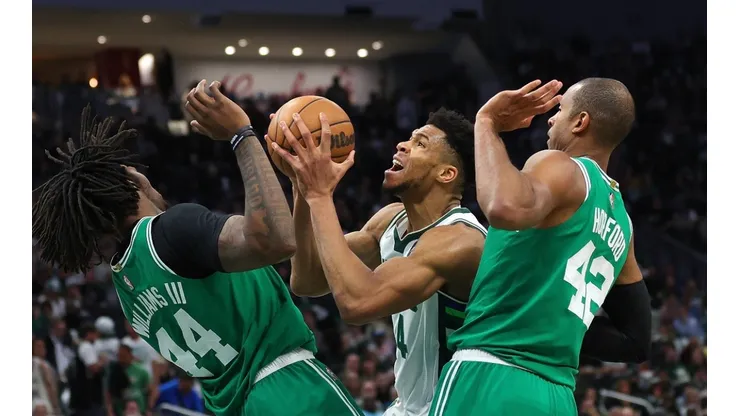 Giannis Antetokounmpo of the Milwaukee Bucks guard by Robert Williams III and Al Horford of the Boston Celtics