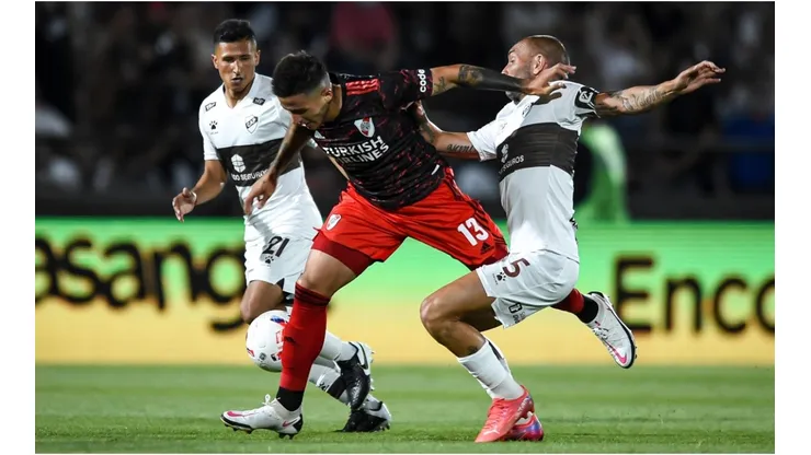 Enzo Fernandez of River Plate fights for the ball with Hernan Lamberti of Platense