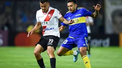 Jorge Flores of Always Ready fights for the ball with Eduardo Salvio of Boca Juniors