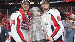 John Carlson (left) and Andre Burakovsky of the Washington Capitals pose with the Stanley Cup trophy in 2018.