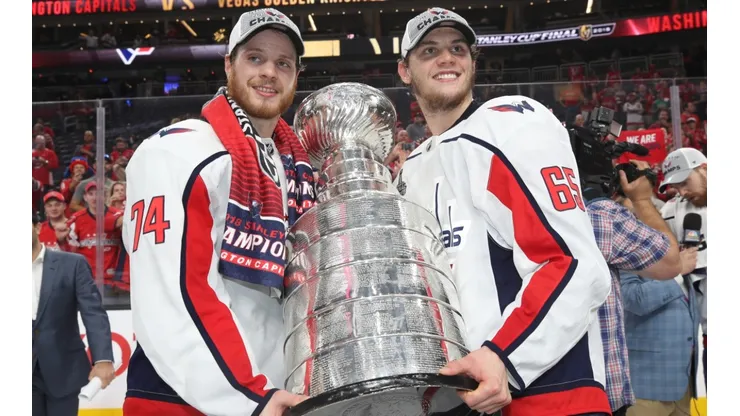 John Carlson (left) and Andre Burakovsky of the Washington Capitals pose with the Stanley Cup trophy in 2018.