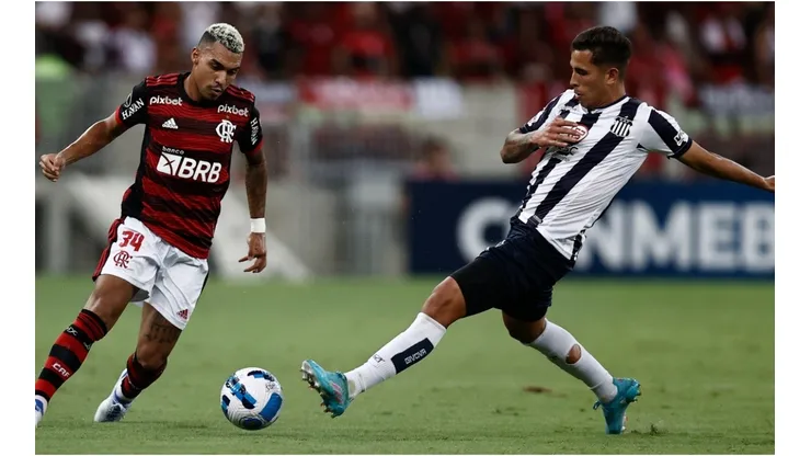 Matheuzinho (L) of Flamengo competes for the ball with Oliva of Talleres