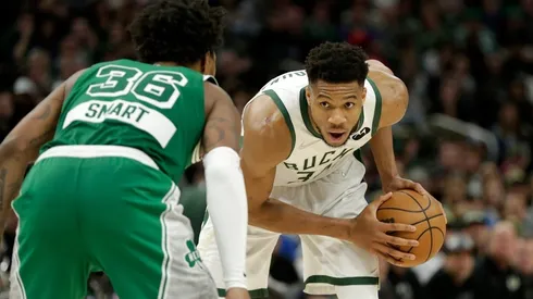 Giannis Antetokounmpo of the Milwaukee Bucks looks to drive on Marcus Smart of the Boston Celtics