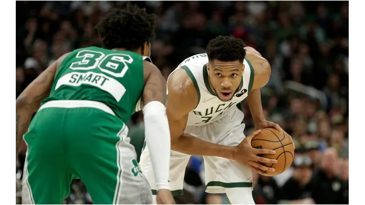 Giannis Antetokounmpo of the Milwaukee Bucks looks to drive on Marcus Smart of the Boston Celtics