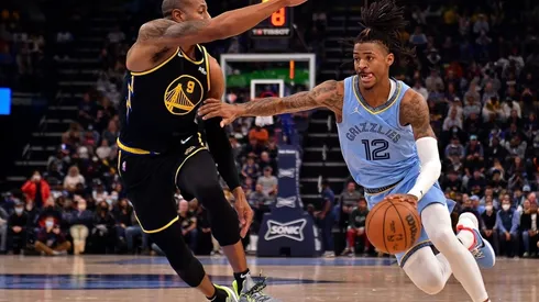 Ja Morant of the Memphis Grizzlies goes to the basket against Andre Iguodala of the Golden State Warriors
