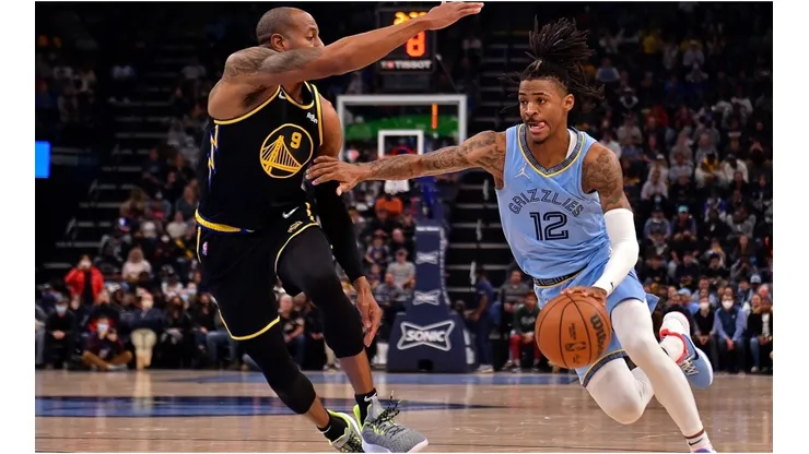 Ja Morant of the Memphis Grizzlies goes to the basket against Andre Iguodala of the Golden State Warriors