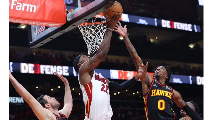 Jimmy Butler of the Miami Heat attacks the basket against Danilo Gallinari and Delon Wright of the Atlanta Hawks