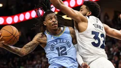 Ja Morant of the Memphis Grizzlies goes up for a shot while Karl-Anthony Towns of the Minnesota Timberwolves defends